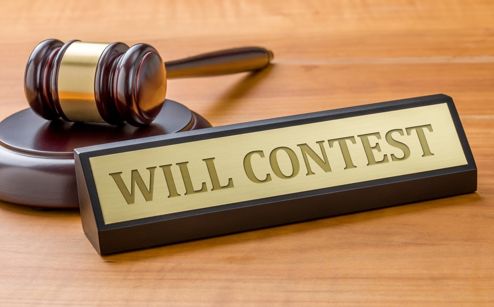 Gavel and "WILL CONTEST" nameplate on wooden desk, symbolizing legal disputes over wills and estate planning in Colorado.