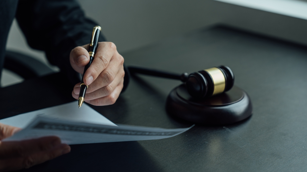 Estate planning documents and gavel, symbolic of estate litigation